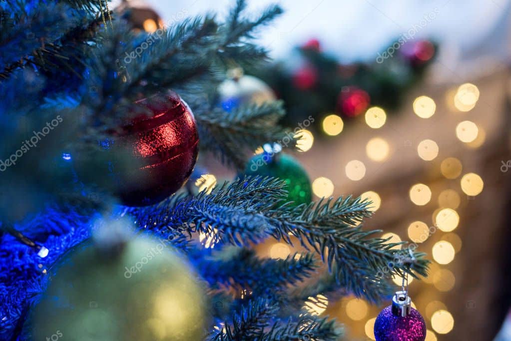 selective focus of beautiful decorated christmas tree with shiny baubles