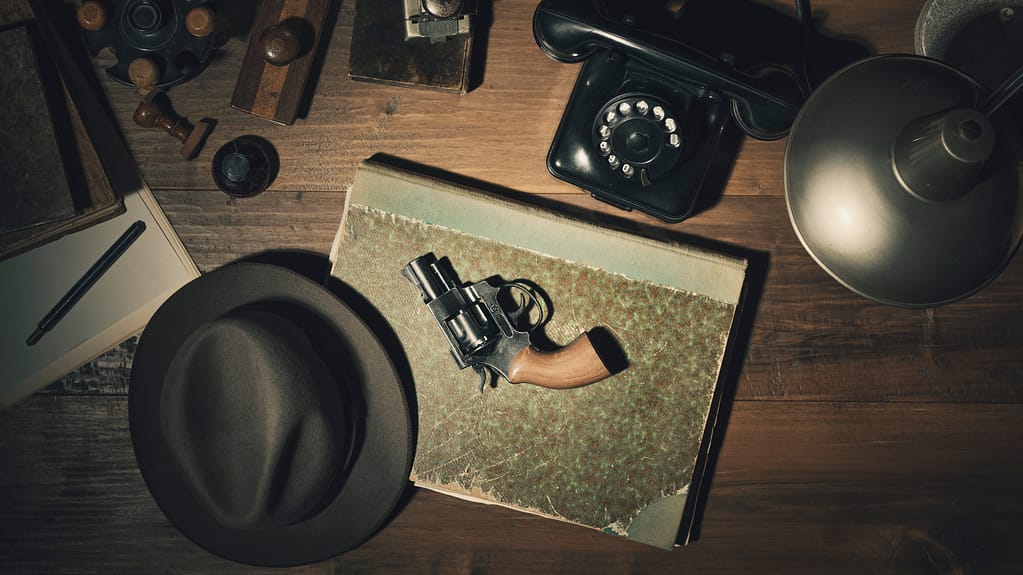 Noir 1950s style detective desktop with revolver