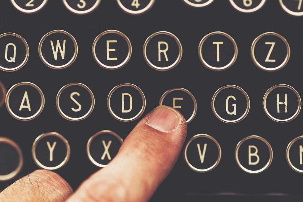 Finger on vintage typewriter machine